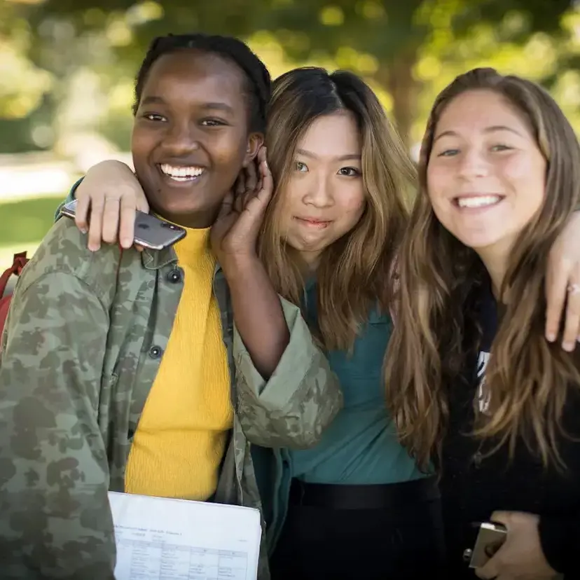 Students grouped together smiling for photo