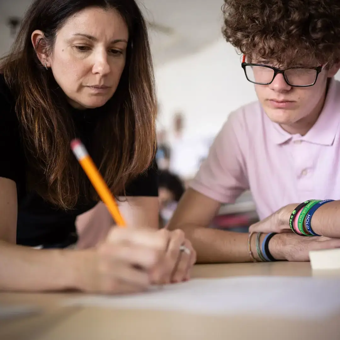 Student and teacher working on project together