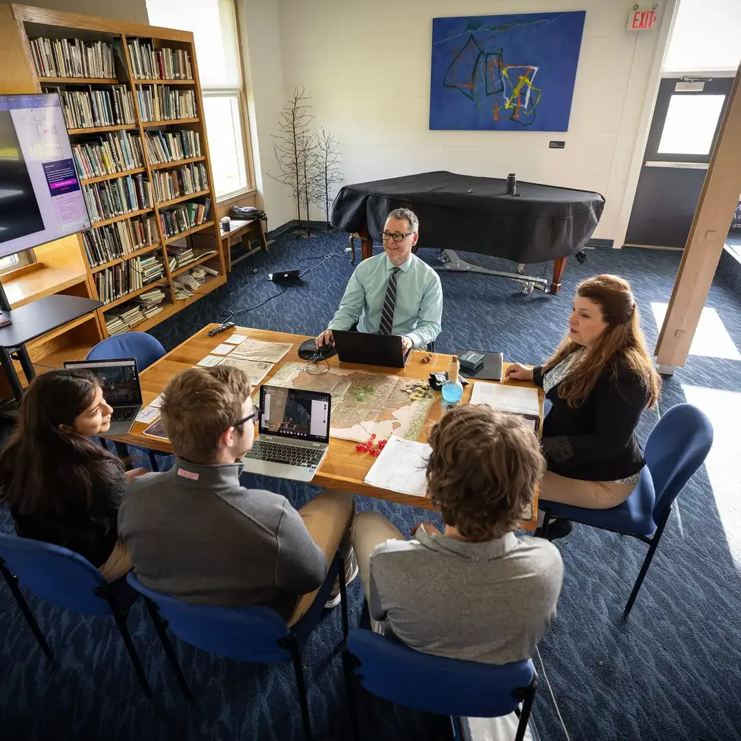 Teachers and students discussing in library