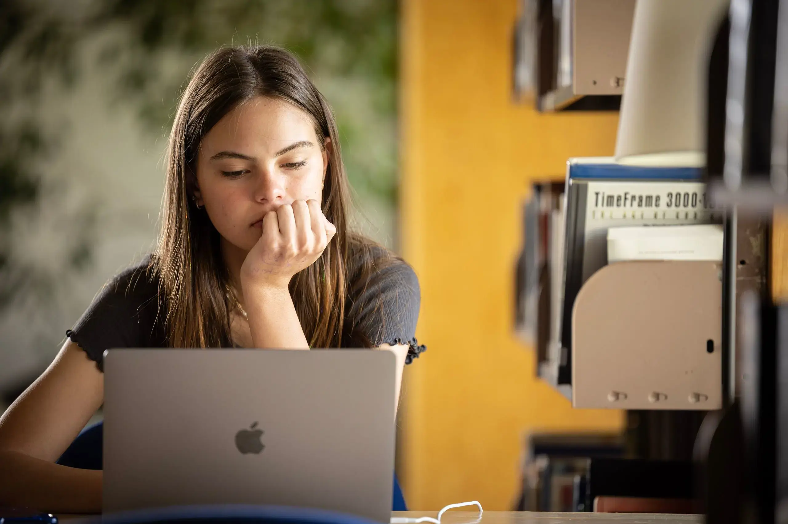 Student doing schoolwork on laptop