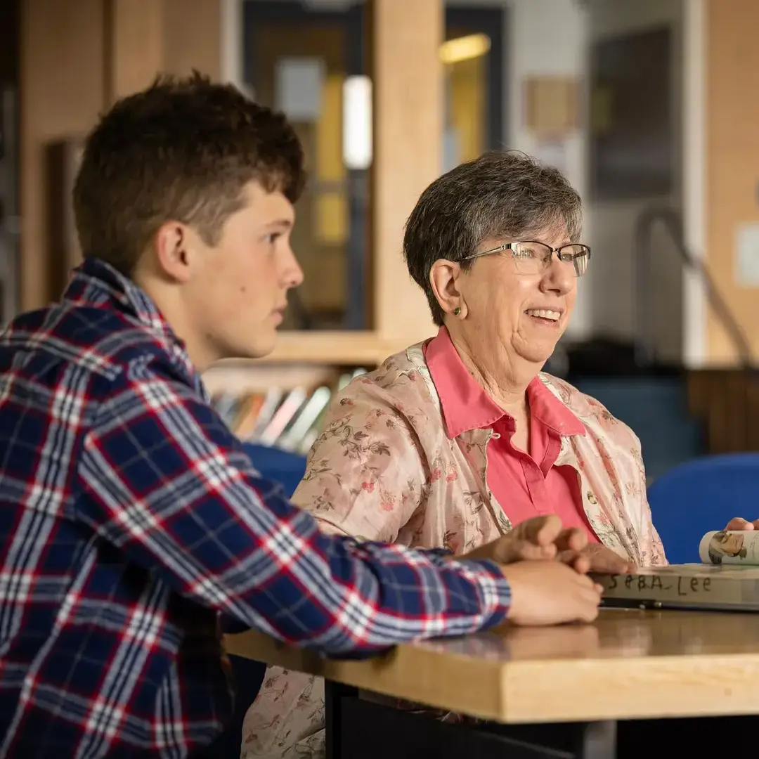 Student and teacher in library