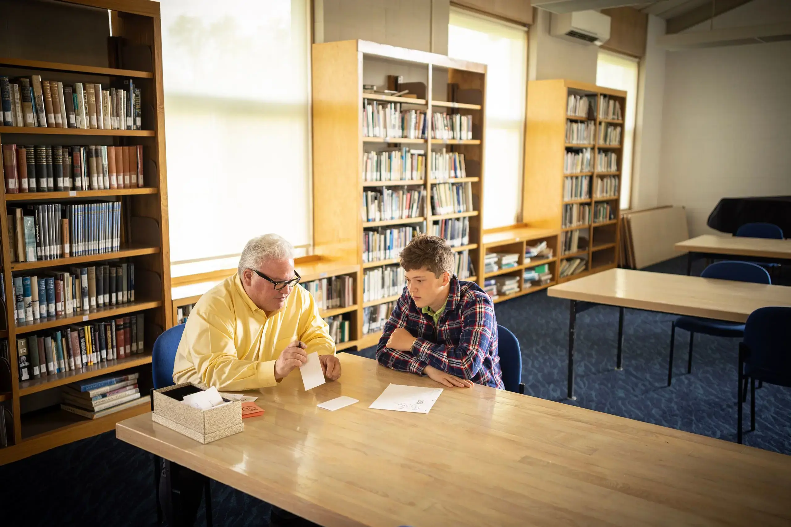 Student and teacher in library together