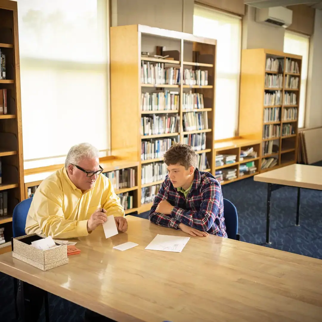 Student studying with teacher
