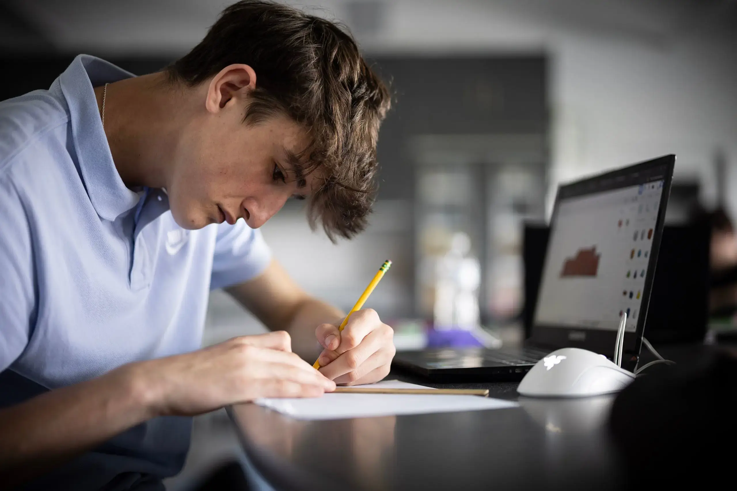 Student doing science classwork on laptop