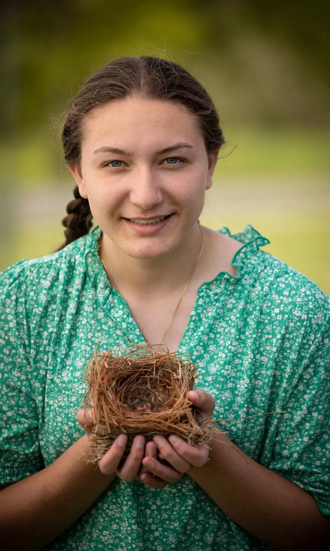 Student holding bird nest