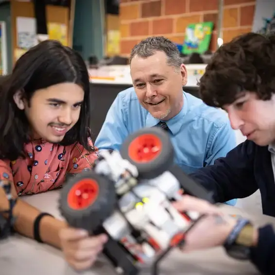Teacher assisting students in science class