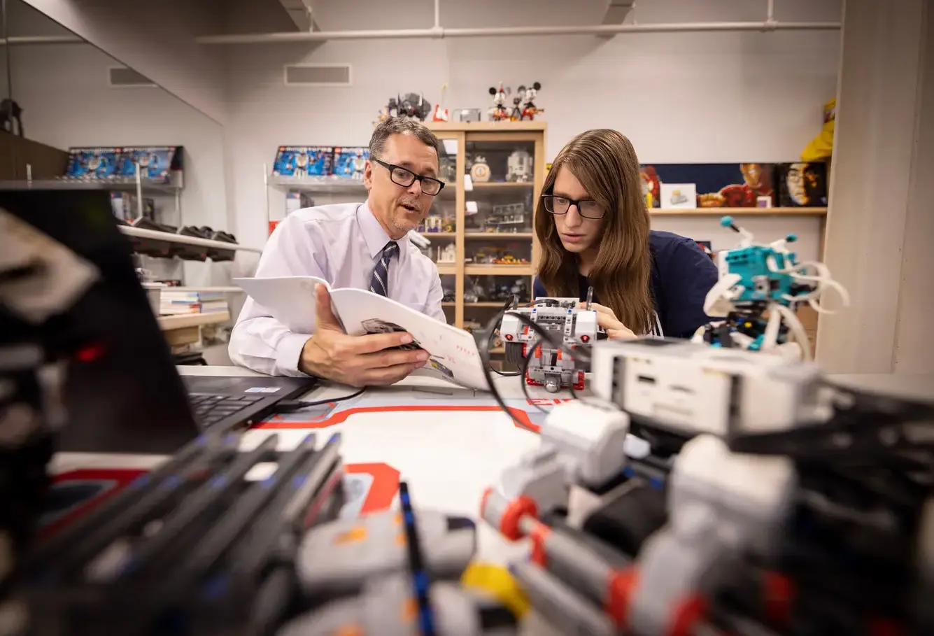 Student and teacher in robotics class