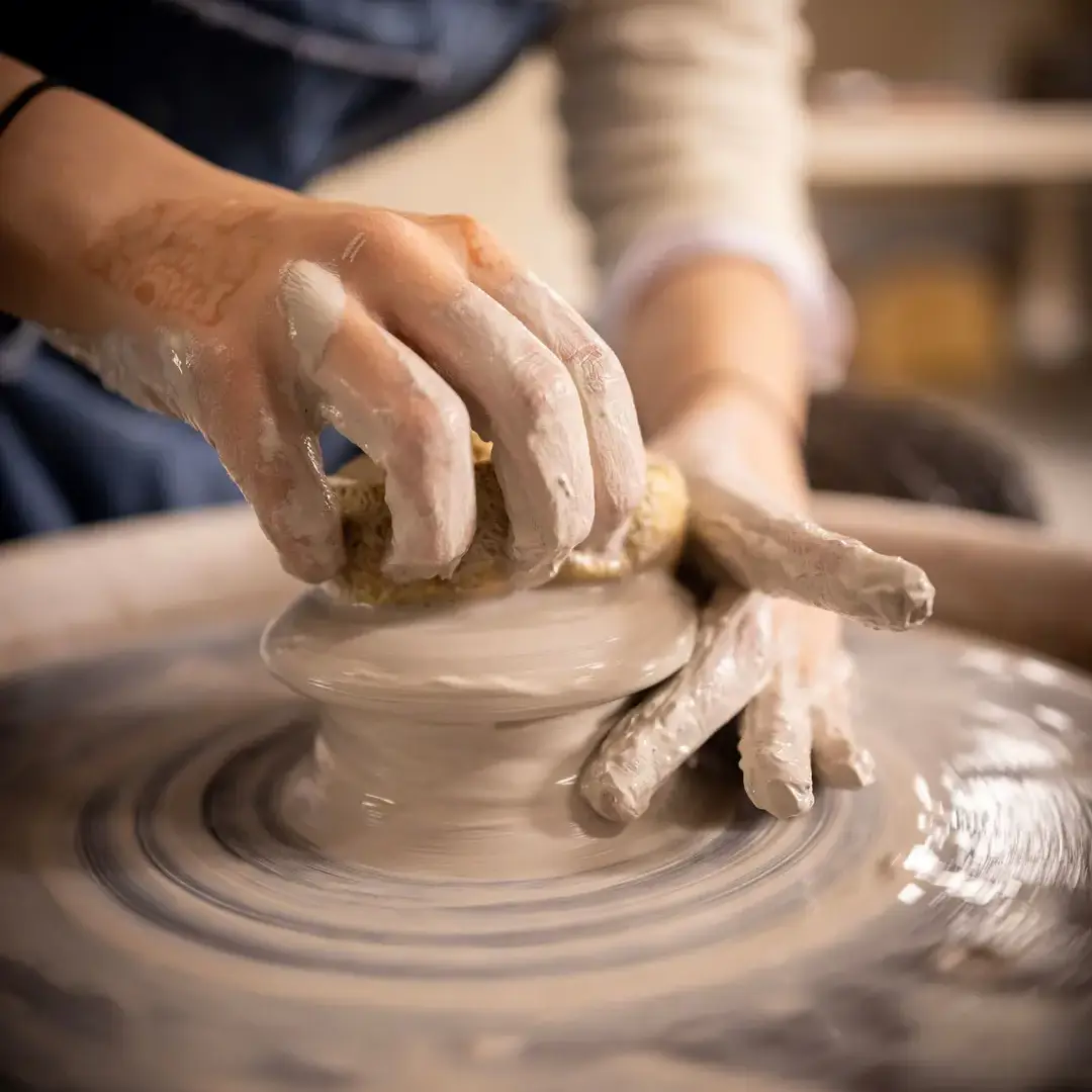 Student using pottery wheel