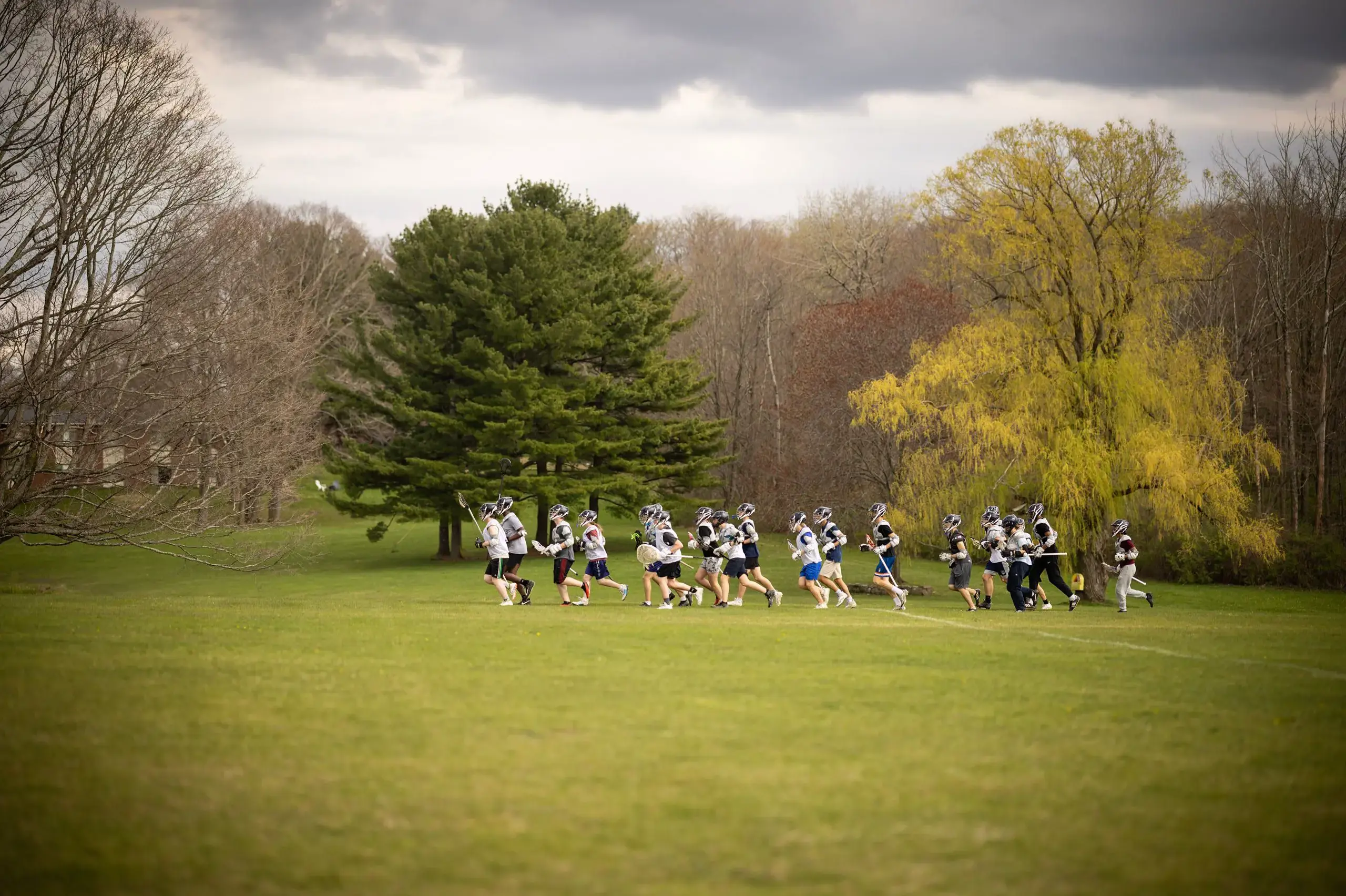 Students playing Lacrosse on field
