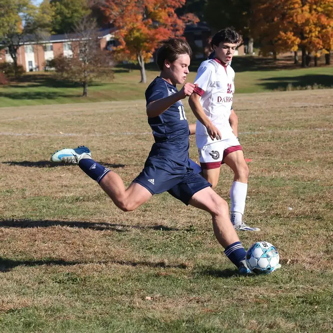 Student kicking soccer ball