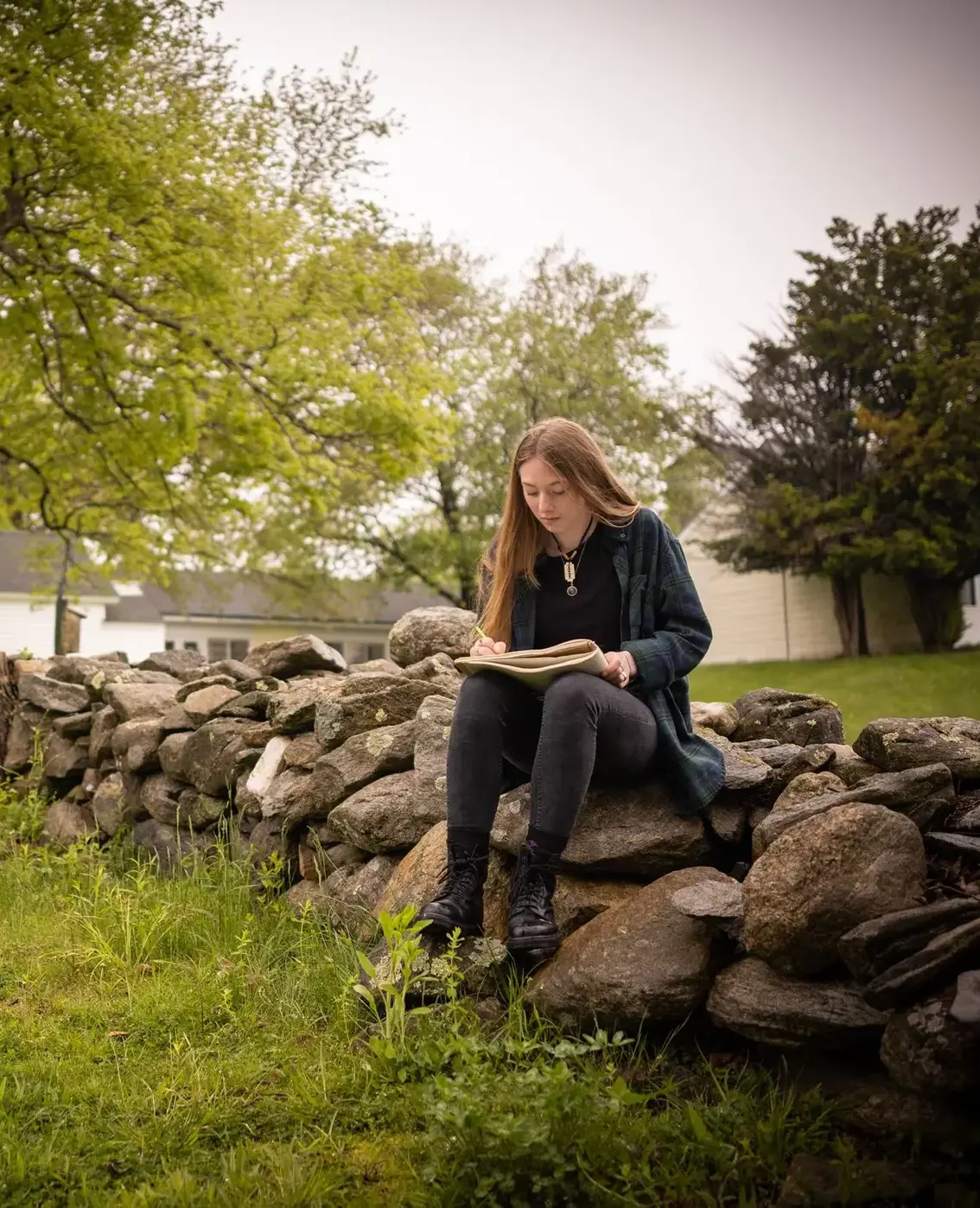 Student doing classwork on campus outdoors