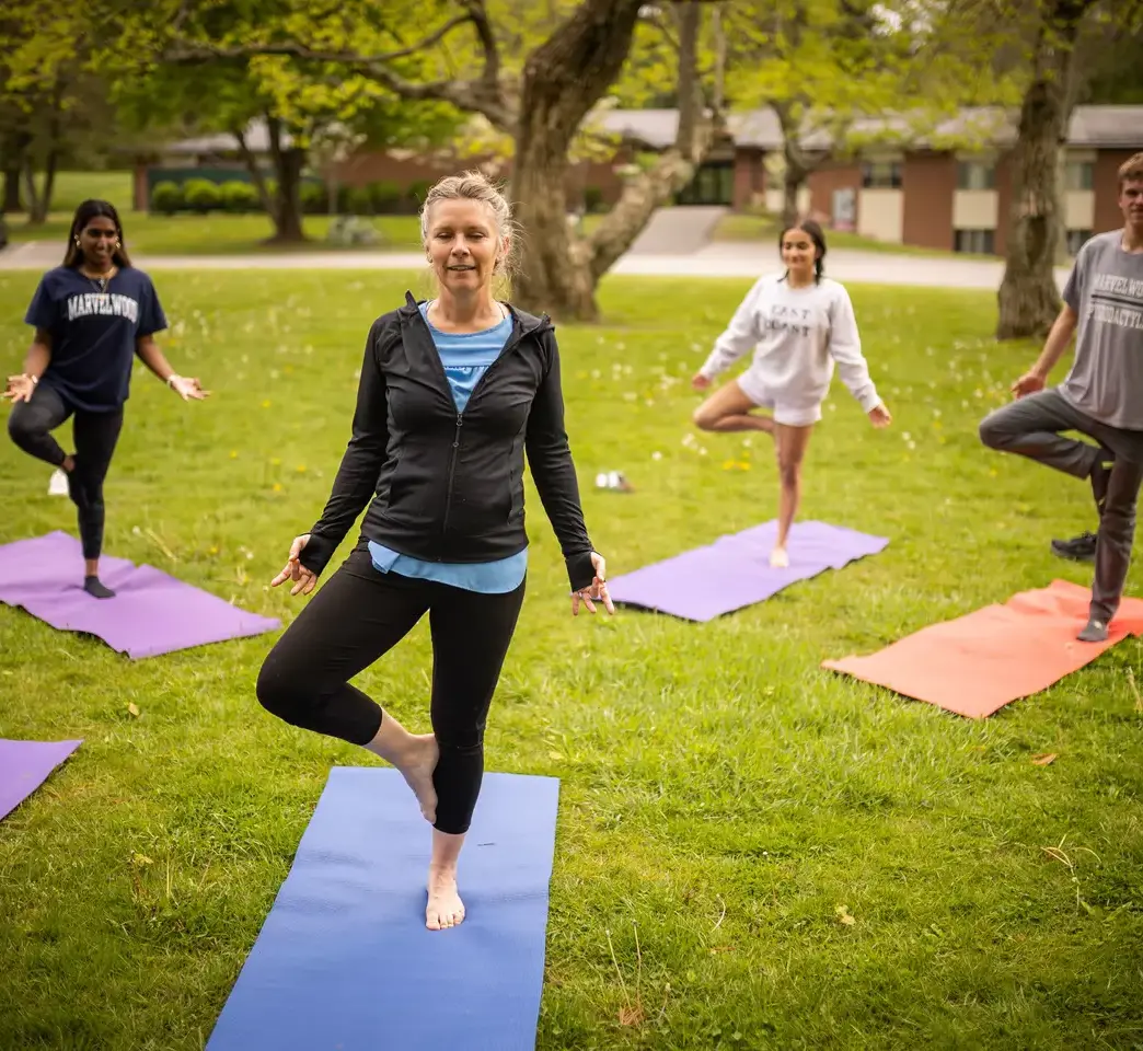 Students and teacher doing yoga elective