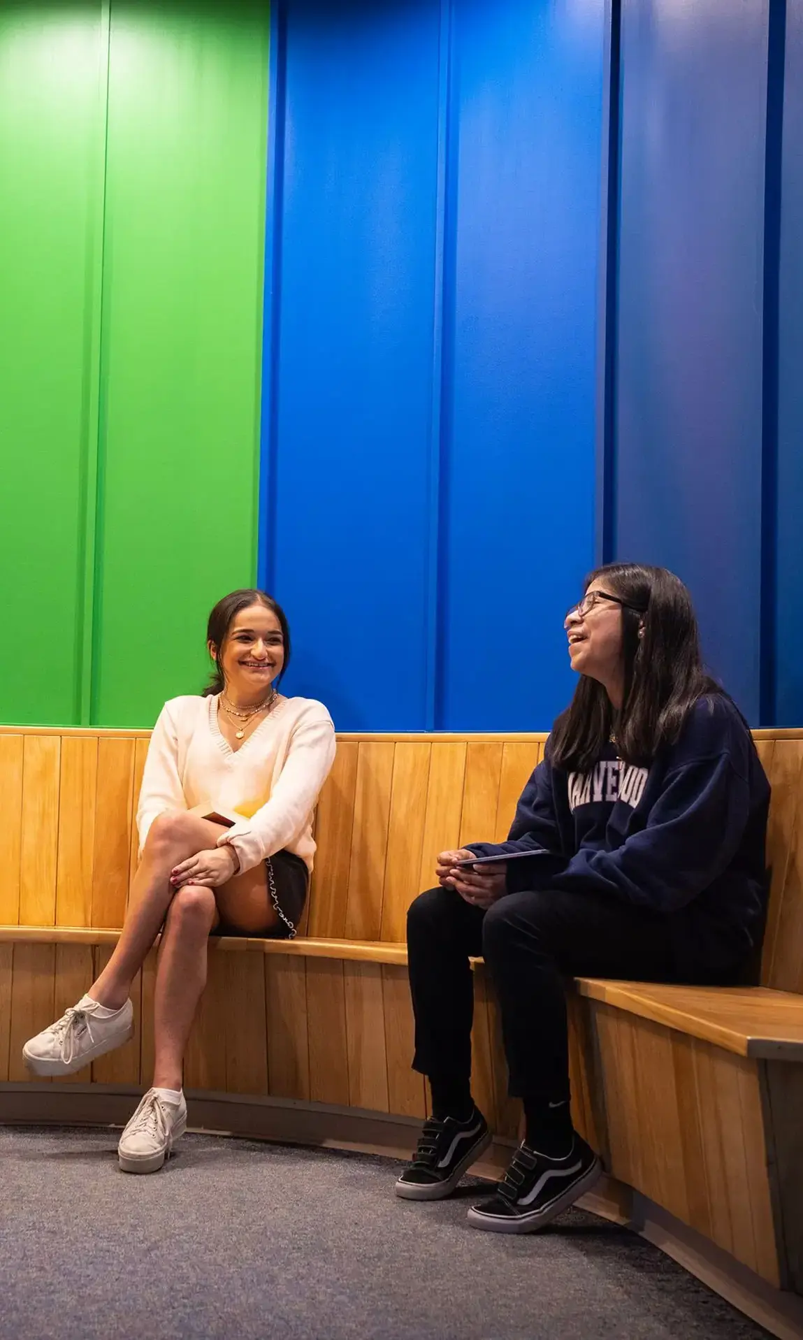 Students chatting in front of mural
