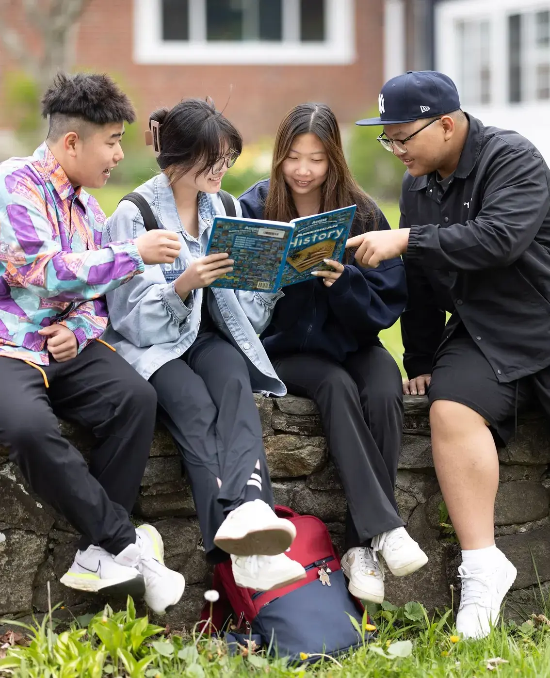 Multiple students reading book together