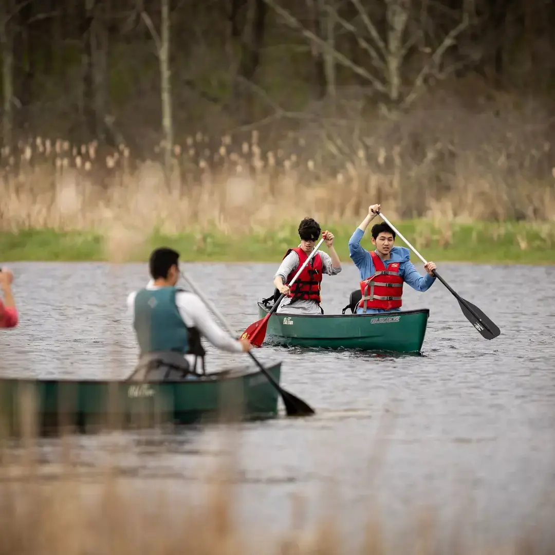 Students kayaking on lake