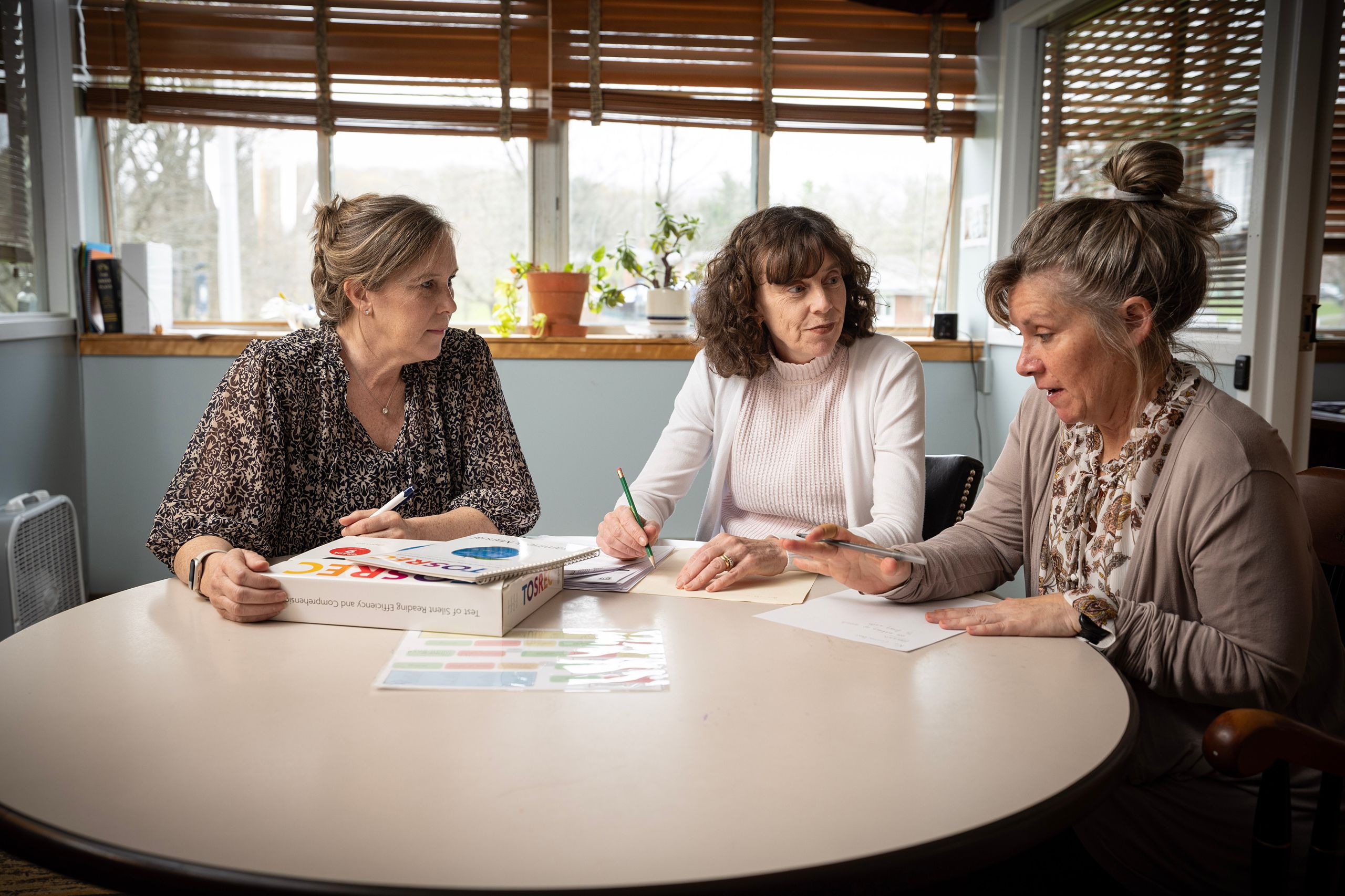 Faculty discussing around table